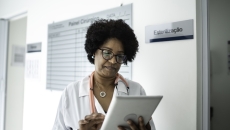 Clinician reviewing patient information Clinician reviewing patient information