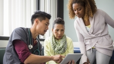 Healthcare worker consulting with a patient and family member Healthcare worker consulting with a patient and family member