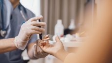 Doctor taking a patient's blood sample in a clinic Doctor taking a patient's blood sample in a clinic
