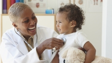 Healthcare provider checking a small patient Healthcare provider checking a small patient
