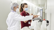 Healthcare professionals standing at a computer Healthcare professionals standing at a computer
