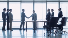 Business representatives shake hands to close a deal Business representatives shake hands to close a deal