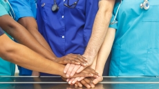 Healthcare providers putting their hands together Healthcare providers putting their hands together