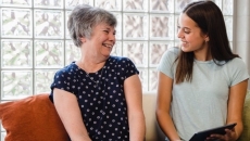 A woman using the LifeBio app with a caregiver A woman using the LifeBio app with a caregiver