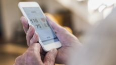 Person reviewing data on a cell phone screen Person reviewing data on a cell phone screen