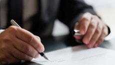 Person signing a document Person signing a document