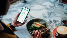 A person using a phone to track the calories in a salad