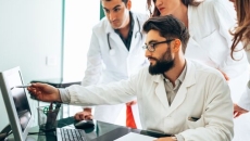 Clinicians look at screen