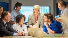 Businesspeople and doctors in a meeting together. Businesspeople and doctors in a meeting together.