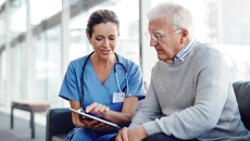 Provider gives options to patient while looking at a tablet or notepad Provider gives options to patient while looking at a tablet or notepad
