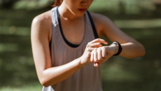 A runner checking their vital signs on their fitness tracker A runner checking their vital signs on their fitness tracker
