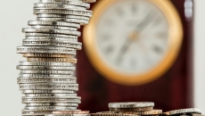 Coins and a clock on background Coins and a clock on background