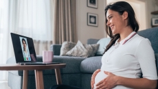 A pregnant person talking to a provider on a tablet A pregnant person talking to a provider on a tablet