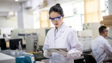 Researcher looking at a tablet Researcher looking at a tablet