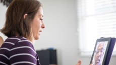 A person talking to a provider on a video call via tablet A person talking to a provider on a video call via tablet