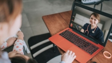 A woman talking to a provider via her laptop A woman talking to a provider via her laptop