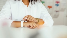 A close-up of a person sitting while wearing a smartwatch A close-up of a person sitting while wearing a smartwatch