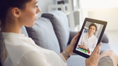 A woman talking to a provider on her tablet A woman talking to a provider on her tablet