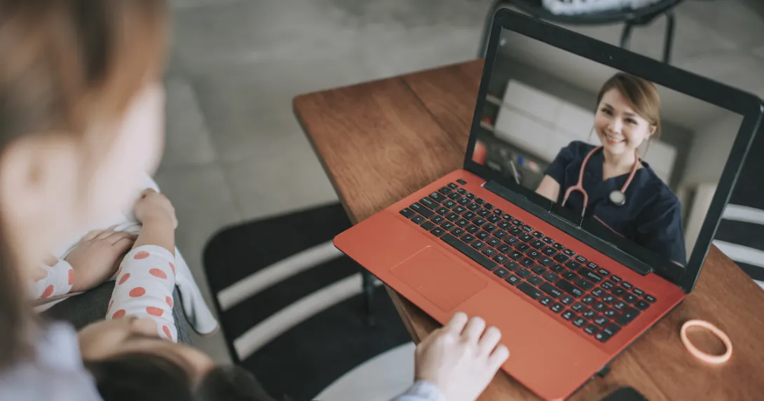 Person sitting down looking at a computer on a coffee table, talking to a healthcare provider
Person sitting down looking at a computer on a coffee table, talking to a healthcare provider