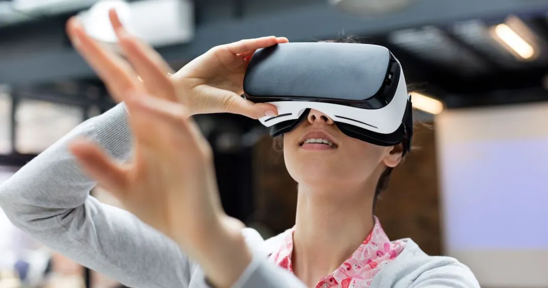 Person using a virtual reality headset with their arms extended above their head Person using a virtual reality headset with their arms extended above their head