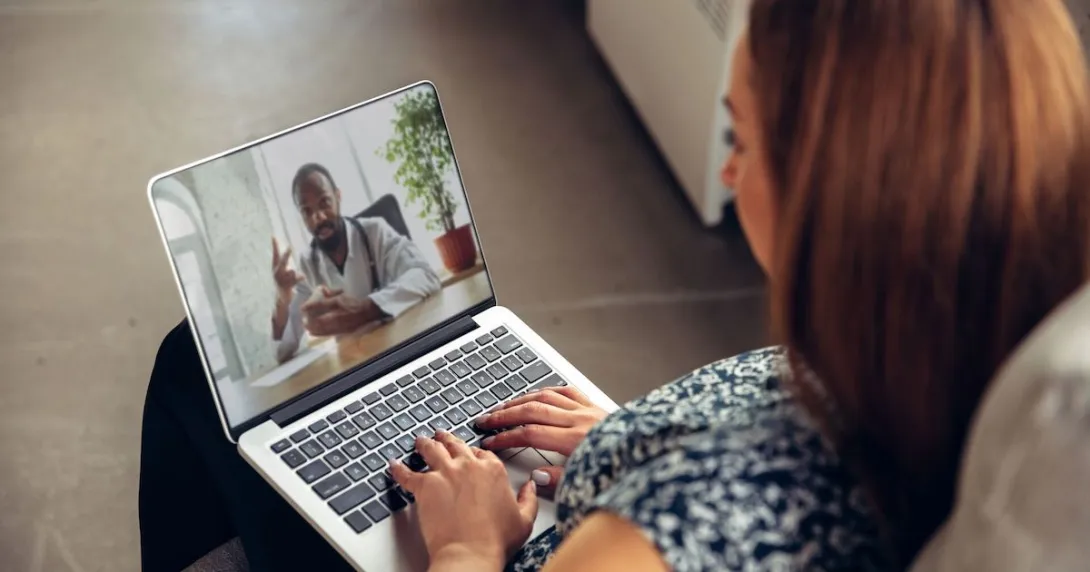 Person on a telehealth call on their laptop Person on a telehealth call on their laptop