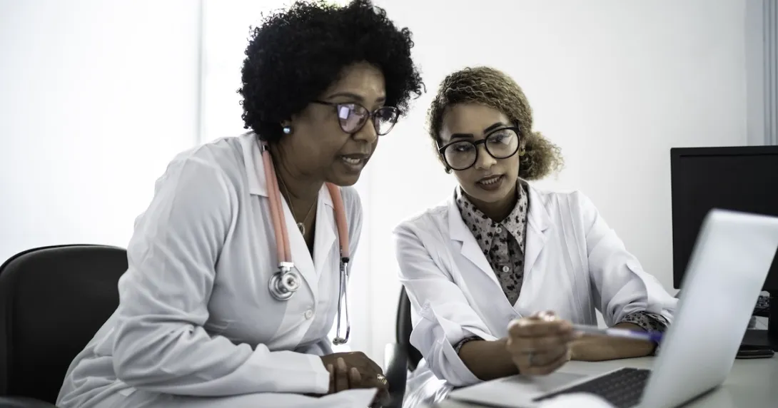 Healthcare professionals reviewing data on a labtop Healthcare professionals reviewing data on a labtop